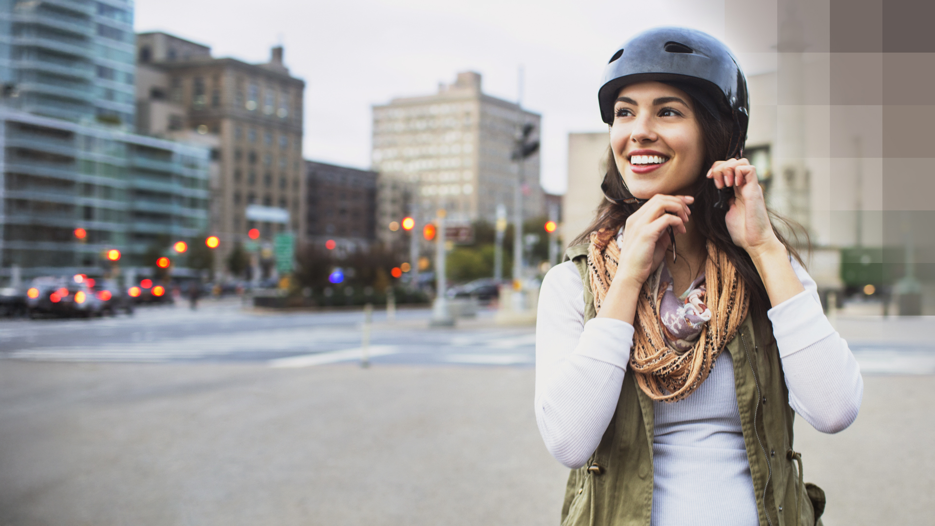 Une jeune femme se tient dans la rue avec un casque de vélo et pense à son assurance d'hospitalisation commune.